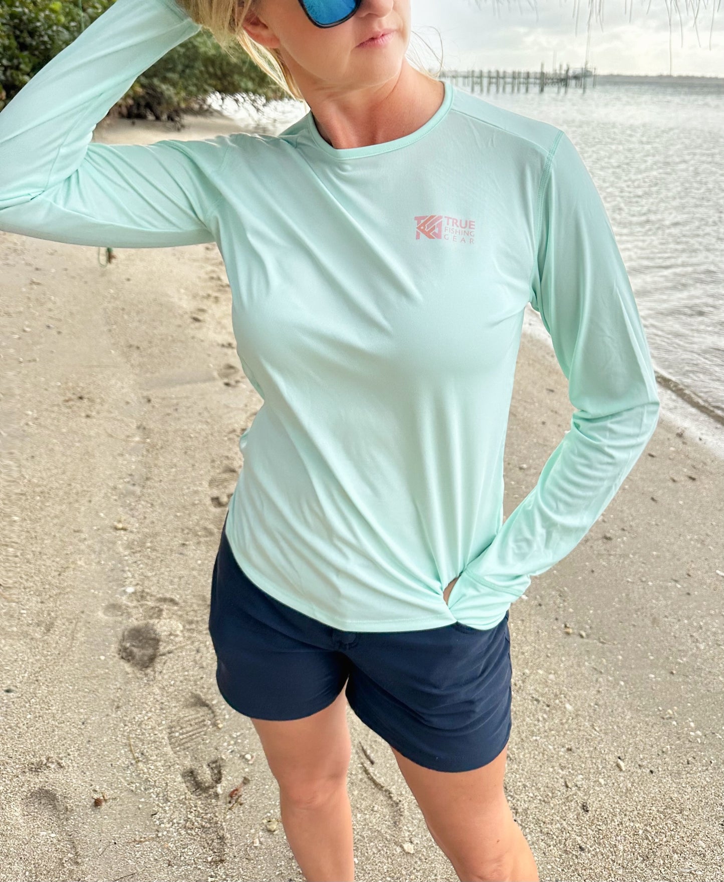 Frint view of woman wearing pale mint UPF Fishing Shirt